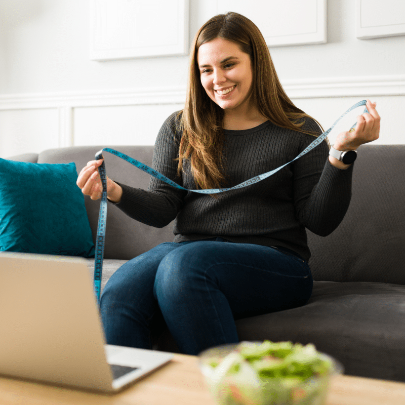 Woman showing how much weight she has lost