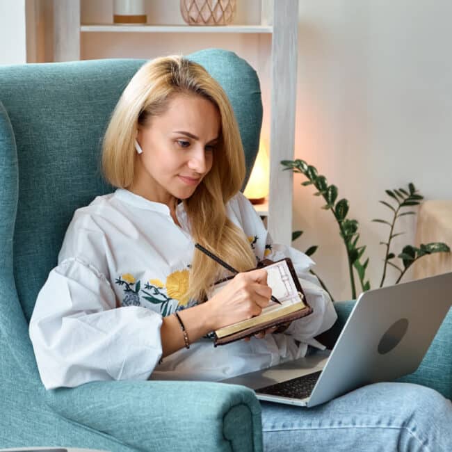 woman writing in journal for health coaching