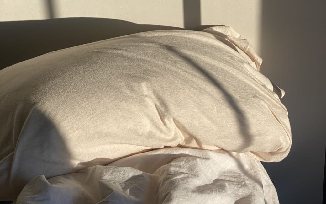 image of shadows on an unmade bed